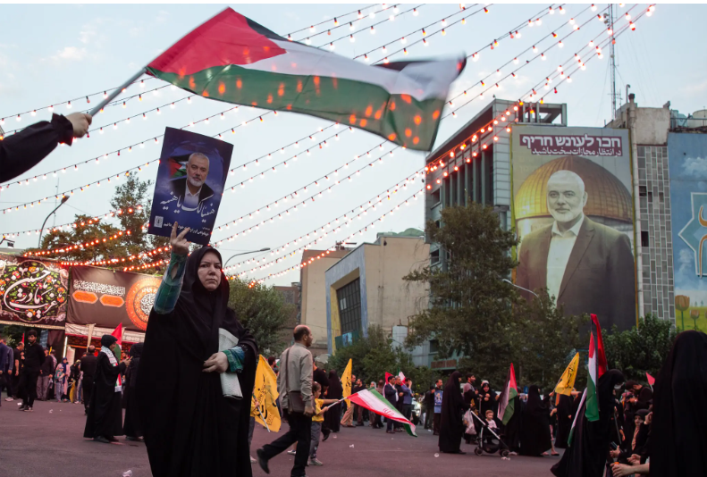 lady carrying Hamas leader Haniyeh photo.